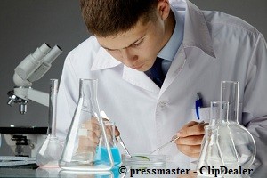 Young biochemist guy working in a laboratory