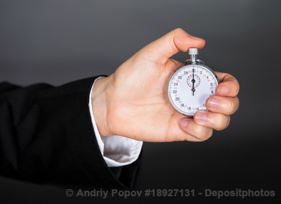 Business man holding stop watch in his hand
