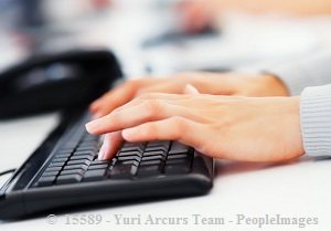 Woman's hand typing on black keyboard