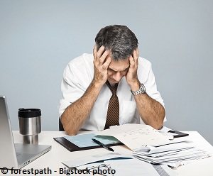 A business person who is very depressed after making a mistake