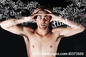 man fed up with lots of thoughts and ideas and holding his head with his hands