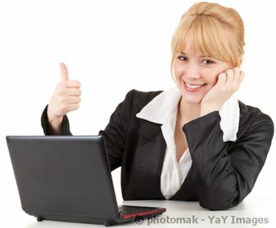 woman working on computer with a thumbs up