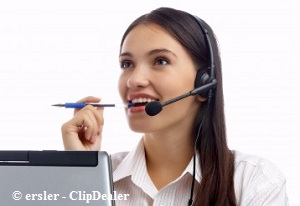 Girl working on her laptop with a pen in her teeth