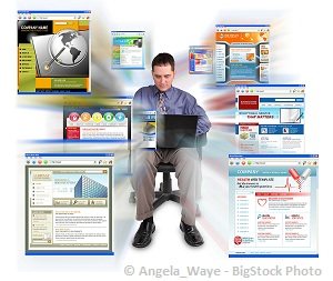 man working on a laptop with many windows open at the same time