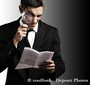 Man in black suit researching something with magnifying glass