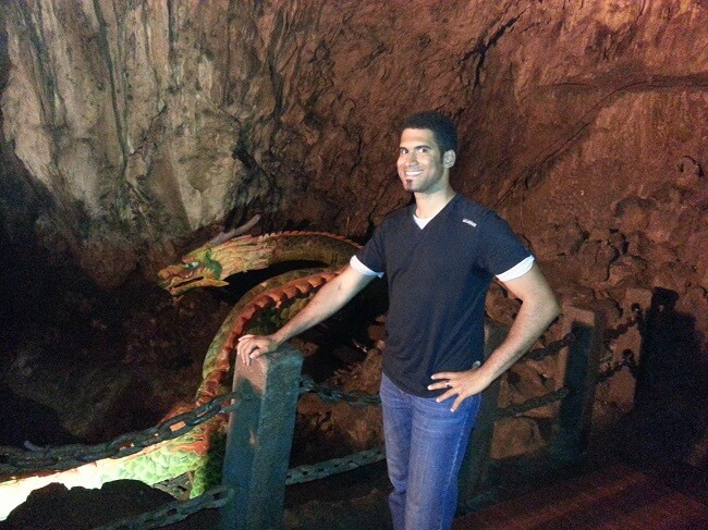 Francis posing with a dragon in chinese underwater cave